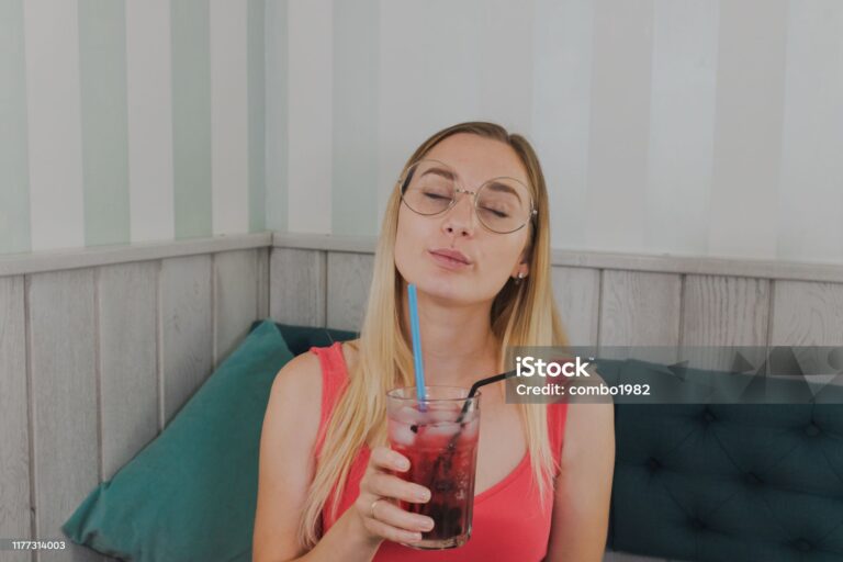 Girl in a cafe drinks sweet desserts with a drink