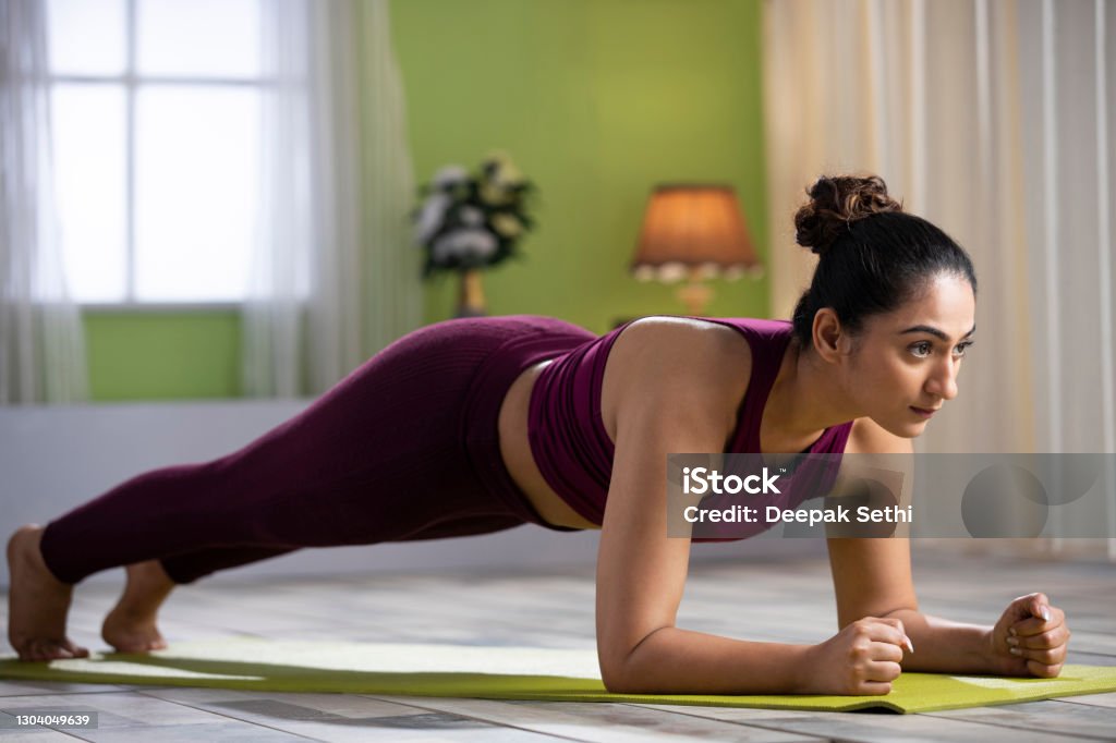 young woman doing yoga at home