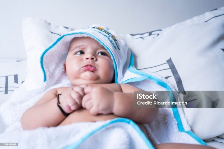 Newborn baby covered with a towel lying down