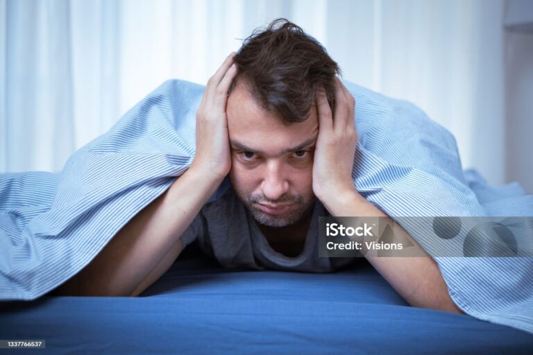 Man waking up and feeling bad in the morning